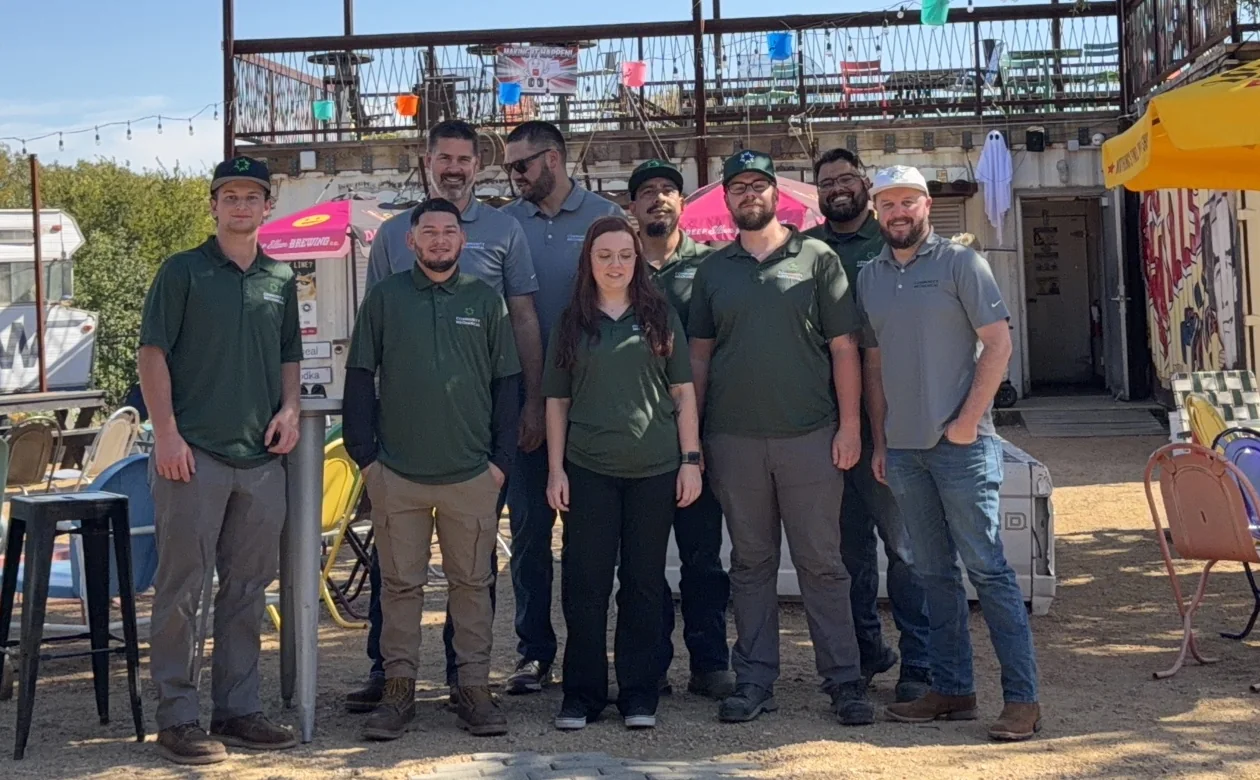 The Community Mechanical team, ten people in company polos, standing together outdoors